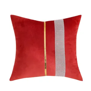 Red velvet cushion cover with gold stripe and rhinestone decor, perfect for elegant home decor.