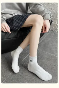 Detailed view of women white short socks featuring cute black panda embroidery for daily wear.