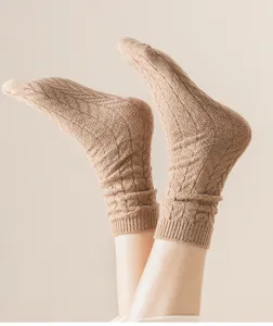 Detailed shot of cozy beige knitted thick winter crew socks showcasing soft fleece texture.