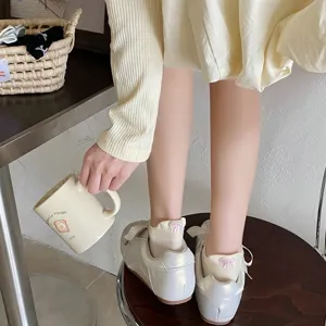Cute cotton white short socks for women with sweet pink bow back detail, breathable everyday wear.