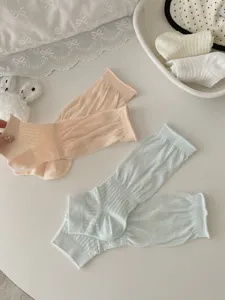 Close up detail view of ultra thin breathable mesh stirrup socks in pastel colors for summer.