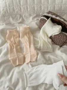 Detail shot of summer ultra-thin footless stirrup socks and white cute slouch socks.