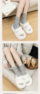 Cozy grey speckle mid-tube socks paired with plush fluffy slippers, perfect for winter comfort detail.
