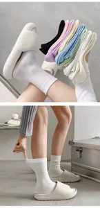 Comfortable solid color casual mid-tube socks paired with cozy slides, perfect for daily wear.