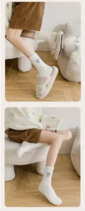 Cozy plush mid-calf socks detail showing soft faux mink fleece texture and cute heart embroidery.