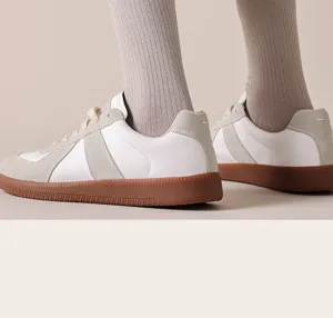Detailed close-up of ribbed mid-calf socks worn with casual sneakers in a clean studio setting.