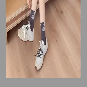 Detail shot of women's mid-tube cotton socks with cute lettuce edge and graphic print.