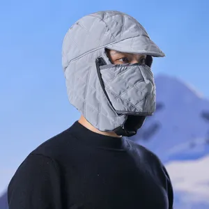 Close-up detail of winter warm trapper hat in gray, featuring quilted design and mask.