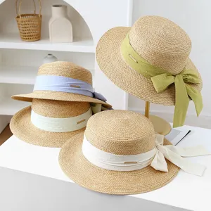 Women's summer flat top straw sun hat with polka dot ribbon bow and wide brim beach hat