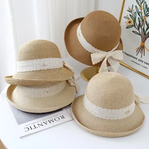 Women summer straw hat with lace ribbon bow, elegant beach sunhat for casual vacation.