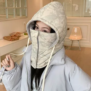 Detailed shot of a thermal padded winter hood and face mask in a cozy cafe setting.
