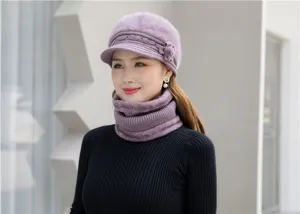 Detailed view of the plush knitted winter hat and matching purple scarf set worn by model.