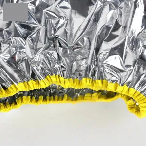 Silver aluminum foil hair cap with yellow elastic band for salon hair perming and oil treatment.