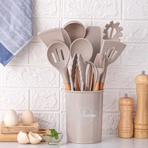 Silicone kitchen utensil set with wooden handles and storage holder for cooking.