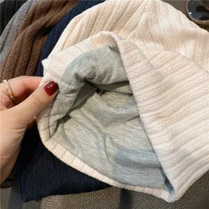 Knitted sleep cap detail view, soft pink exterior and grey lining, breathable comfort design.