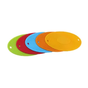 Detail view of colorful silicone heat resistant pot mats and table trivets with hanging holes.