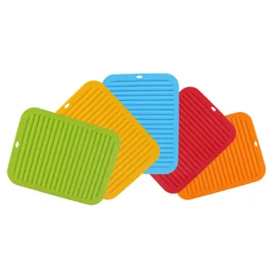 Colorful silicone hot pads, heat-resistant table mats, and non-slip pot holders with hanging holes.