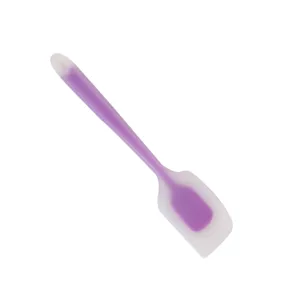 Silicone baking spatula detail shot, translucent purple design for kitchen cooking tasks.