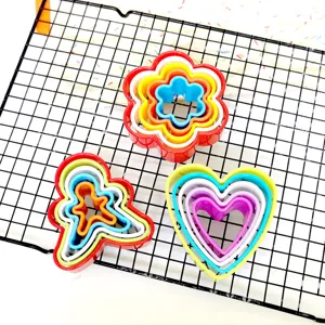 Colorful 5-piece plastic cookie cutter set detail featuring nested heart, flower, and gingerbread shapes.