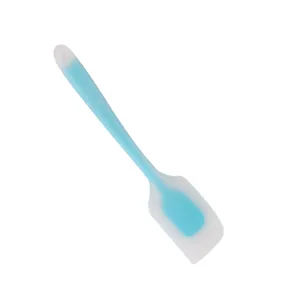 Large translucent silicone spatula for baking cakes, kitchen utensil close up detail view.