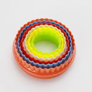 Colorful plastic round scalloped cookie cutter set, nested baking pastry mold kitchen tools.