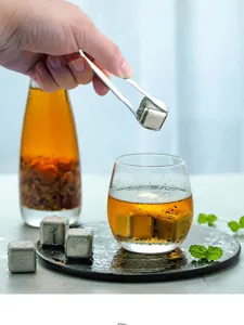 Stainless steel ice tongs set with metal ice cubes for whiskey cocktails and bar use detail view