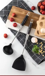 Stainless steel silicone kitchen spatula and soup ladle detail view, heat resistant tool.