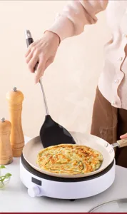 Silicone cooking spatula with stainless steel handle, heat resistant tool for pans.