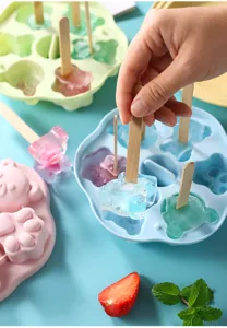 Close-up detail of cute bear silicone ice cube tray with finished bear shaped popsicles.