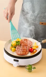 Detailed view of teal silicone spatula with colorful speckles cooking food in frying pan.