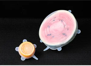Silicone stretch lids detail showing elasticity and tight fit on fruits, kitchen accessory.