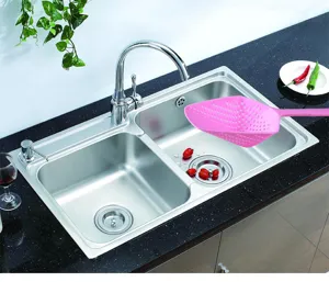 Pink plastic kitchen colander slotted spoon water draining tool for cooking and food preparation.