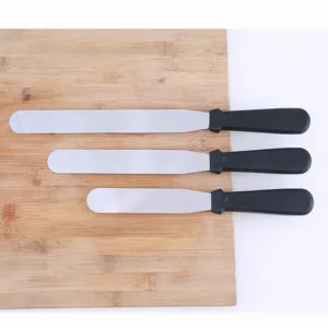 Stainless steel cake spatula detail shot, displaying three different sizes with black handles.