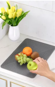 Silicone kitchen sink faucet draining mat detail view, flexible cuttable anti-splash drying pad.
