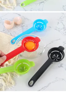Close-up detail of plastic egg white separator spoon with hollow out design for kitchen use.
