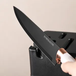 Stainless kitchen knife set with built-in sharpener block, black blade and white handle.
