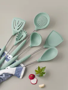 Detail view of stylish green silicone kitchen utensils set featuring ergonomic diamond pattern handles.