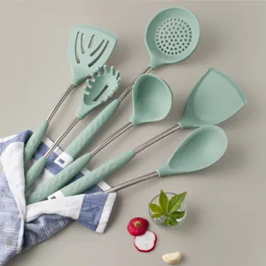 Mint green silicone kitchenware set with stainless steel handles, stylish cooking tools.