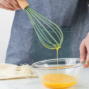 Wooden handle silicone whisk for kitchen baking, ergonomic egg beater tool for home cooking use.