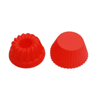 Red silicone muffin cup and pumpkin cake mold set for baking delicious mini puddings and desserts.