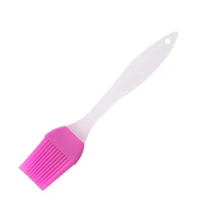 Silicone basting brush for baking, BBQ oil brush with white handle and pink head.
