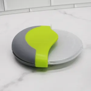 Ergonomic circular pizza cutter wheel with green grey handle for home kitchen use slicing.