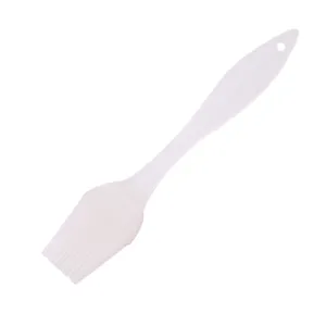 Detailed view of white heat-resistant silicone basting brush for baking and barbecue cooking.