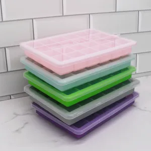 Colorful silicone ice cube trays with lids stacked on kitchen counter, flexible mold.