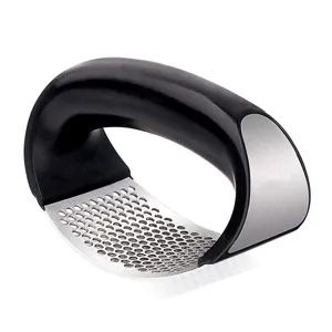 Ergonomic stainless steel garlic press rocker with curved perforated mesh for easy kitchen use.