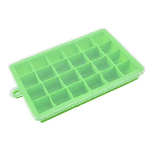 Silicone ice cube tray detail view, flexible green mold with clear protective lid for kitchen.