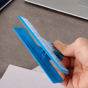 Blue music book clip page holder with steel spring for piano score and sheet music books.