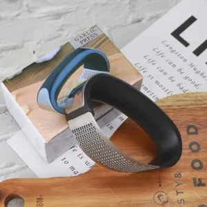 Stainless steel garlic press detail view, ergonomic curved handle for kitchen use, easy mashing.
