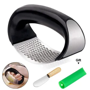 Ergonomic stainless steel curved garlic press rocker with silicone peeler tube and knife.