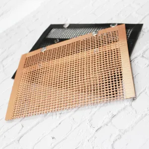 Close-up detail of non-stick mesh BBQ grill mat and bag, heat resistant, ideal for vegetables.